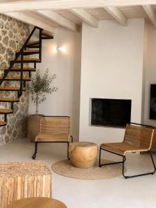 a living room with two chairs and a tv at Villa Tartaya Boutique Villa with Private Pool in Corfu in Dassia