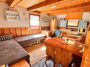 a living room with a bed and a kitchen at Chata u řeky Svatavy in Josefov