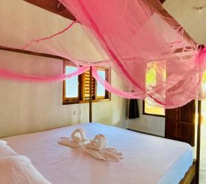 a bed with two towels on top of it at Peanut Farm Cabanas -Surf in Panama
