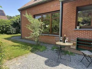 a brick building with a table and a bottle of wine at Hooiland's Hof in Diest