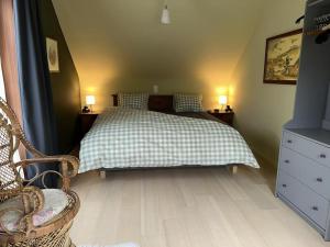 a bedroom with a bed with a checkered blanket at Hooiland's Hof in Diest