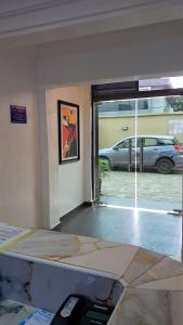 a room with a view of a parking lot at Posh Hotelia in Hausa +11 photos