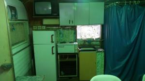 a small kitchen with white appliances and a window at Gradishte beach Ohrid in Ohrid