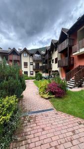 a brick path in front of a apartment complex at La Casina - Centro Colere - 600mt dagli impianti in Colere +10 photos