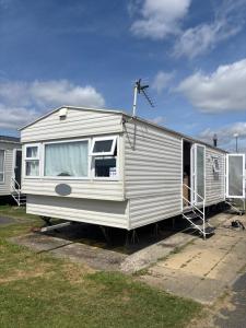 a white rv parked in a parking lot at 159 cambersands in Hastings