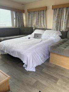 a bedroom with a bed with a laptop on it at 159 cambersands in Hastings