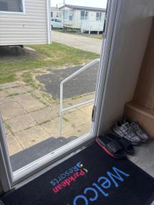 a window with a door with shoes in front of it at 159 cambersands in Hastings
