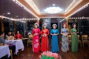 a group of women standing in a room at SHARE Hostel & Coffee in Hue