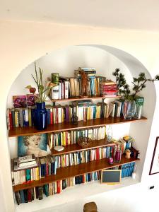 a book shelf filled with books in a room at Giué in Bovalino Marina