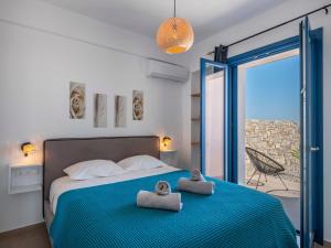 a bedroom with a bed with two towels on it at Cycladic home in Paros in Kampos Paros +53 photos