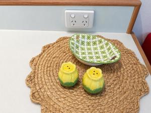 two rubber birds sitting on top of a table at Chelsea Motor Inn in Coffs Harbour