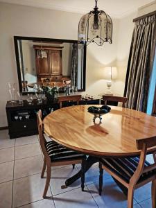 a dining room with a table and a mirror at Francolin's Rest Guest Suite in Sweet Valley