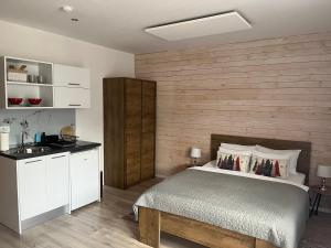 a bedroom with a bed and a wooden wall at MONTANA in Jahorina