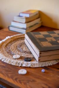 a group of books sitting on a table with a chessboard at Symi Garden Studios in Symi