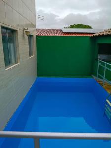 a large blue trampoline in front of a building at Casa do Seu Lourenço in Beberibe +16 photos