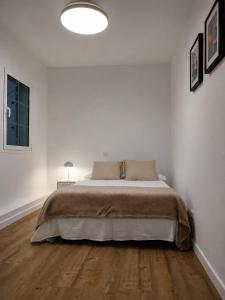 a bedroom with a large bed in a white room at Sardina Beach Retreat in Gáldar