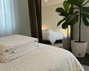 a stack of white towels on a bed in a bedroom at 2 bedrooms living apartments in Lahore
