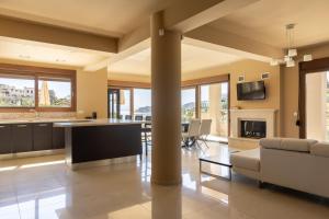 a living room with a couch and a table at Villa Mononaftis in Agia Pelagia