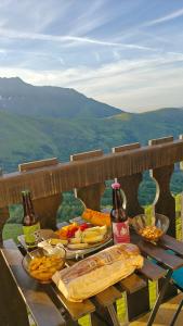 a picnic table with food and two bottles of beer at Laura Studio - Pla d'Adet Pied des pistes - balcon Vue vallée - ménage inclus dès 5 nuits in Saint-Lary-Soulan +37 photos