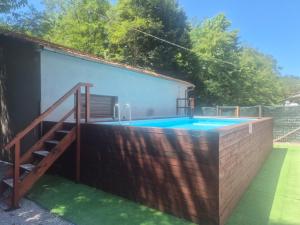 a swimming pool in the backyard of a house at B&B Ducato delle Seimiglia in Camaiore