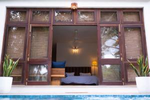 a bedroom with a bed inside of a building at Tropical Grove in Polgolla