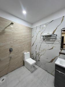 a bathroom with a toilet and a sink at Oasis hotels in Hoshiārpur
