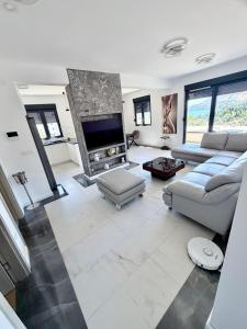 a living room with a couch and a fireplace at S-Penthouse in Herceg-Novi