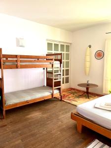 a bedroom with two bunk beds and a table at Giué in Bovalino Marina