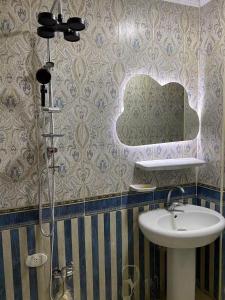 a bathroom with a sink and a mirror at Adel home in Kafr al Ishārah