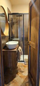 a bathroom with a sink and a glass shower at Tenuta di Monte Gemini in Campagnano di Roma