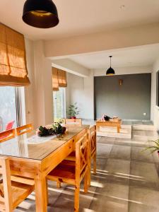 a living room with a wooden table and chairs at Granny's Den - Nathia Gali in Nathia Gali