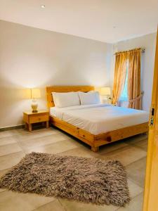 a bedroom with a large bed and a rug at Granny's Den - Nathia Gali in Nathia Gali