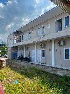 a building with two motorcycles parked outside of it at hb co living in Tanjungredep