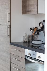 a kitchen with a stove and a counter top at Rooftop privé - Clim - Place Carnot - Wifi in Carcassonne