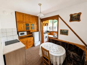 a kitchen with a small table in a kitchen at Апартамент Извор 6 in Smolyan