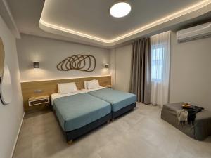 a hotel room with a bed and a window at Evdokia Suites in Gouves +221 photos