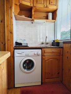 a kitchen with a washing machine in a kitchen at Апартамент Извор 6 in Smolyan
