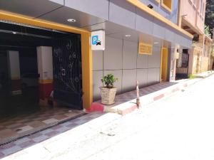 a front door of a building with a potted plant at KA Hôtel Dely Ibrahim in Deli Ibrahim