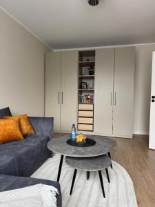 a living room with a couch and a table at Golden corner in Plungė