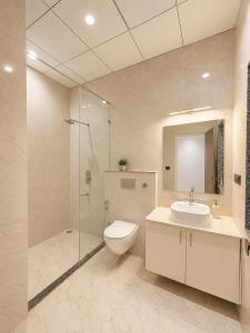 a bathroom with a toilet and a sink and a shower at Private Farm with Big Size Pool & 7 Rooms in Kukas in Jaipur +7 photos