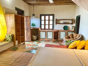 a living room with a couch and a table at Mama Root in Kizimkazi