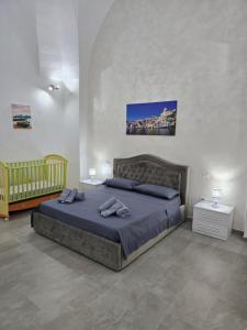 a bedroom with a large bed with blue sheets at Casa Vacanza S Elia in Veglie
