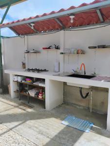 a kitchen with a counter and a sink at A-frame cabin in Parrita
