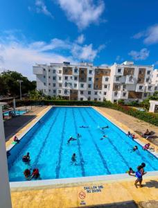 a group of people swimming in a swimming pool at 3 bedroom house buxton in Mombasa
