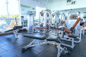 a gym with several tread machines in a room at 3 bedroom house buxton in Mombasa