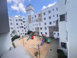 a playground in a courtyard in front of a building at 3 bedroom house buxton in Mombasa