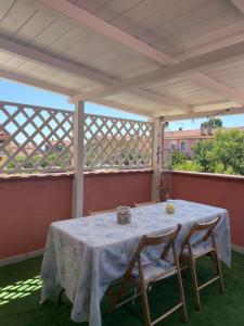 a table and two chairs on a patio at Sweet Home Pia in La Maddalena