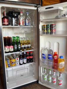 an open refrigerator filled with lots of drinks at Cabaña Con Jacuzzi Privado y Vista a La Montaña in Guarne