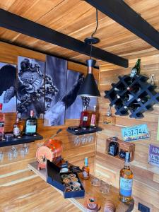 a bar with bottles of alcohol on a wooden wall at Cabaña Con Jacuzzi Privado y Vista a La Montaña in Guarne