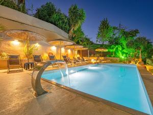 a swimming pool with a water feature in a resort at Holiday Sea View Villas in Katastárion